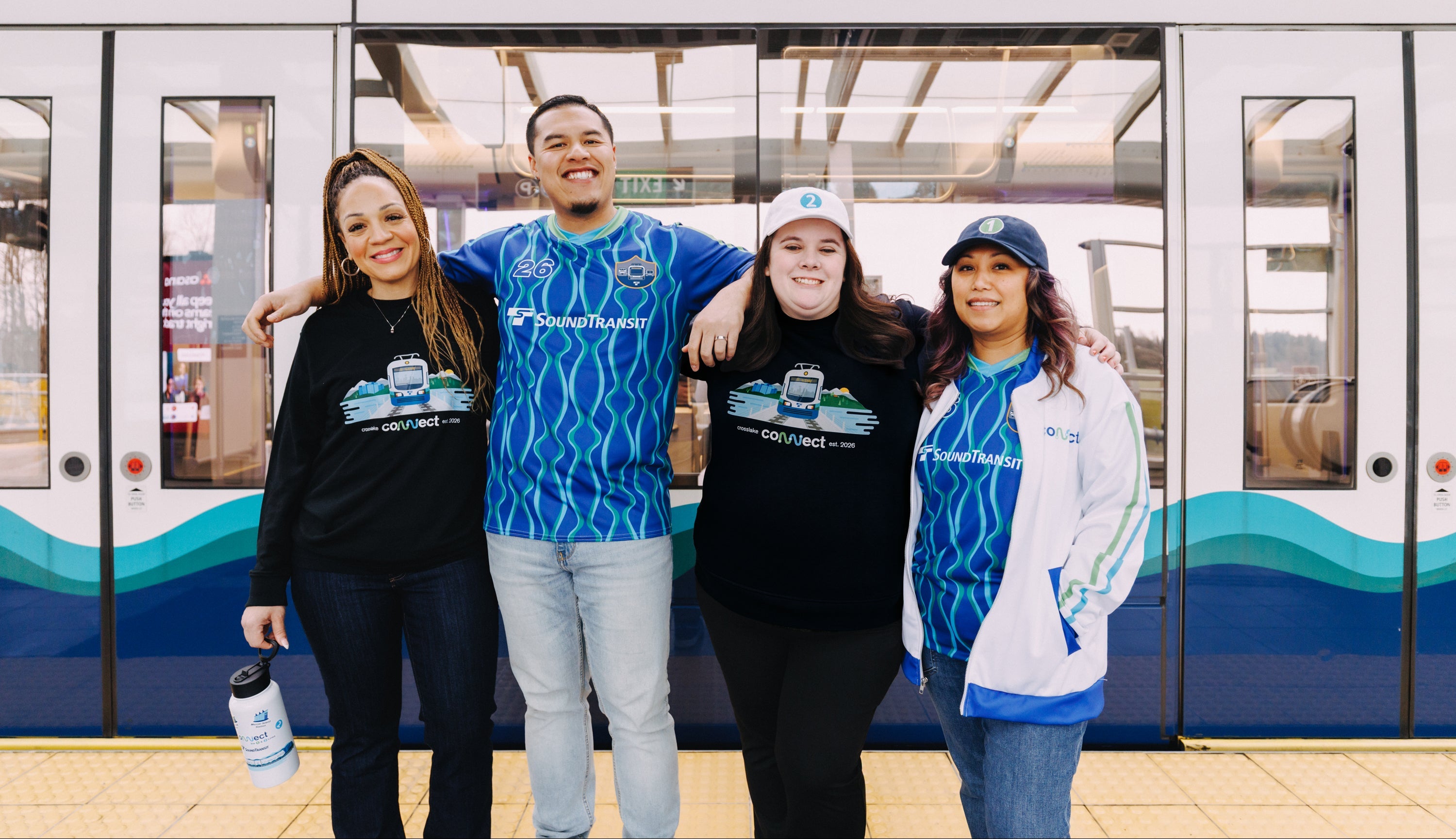 Four transit employees wearing ST shop merch from the Crosslake Connection collection.
